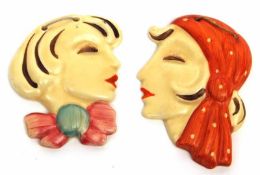 Two Clarice Cliff small Wall Masks, each modelled as Ladies in Art Deco costume, one wearing a bow