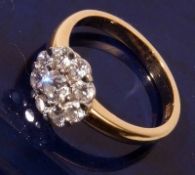 A high grade precious metal design brilliant cut Diamond Cluster Ring of flower head design, the