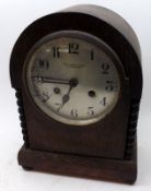 An early 20th Century Oak Cased Mantel Clock, circular dial with black Arabic chapter ring, and