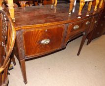 An early 19th Century Mahogany Bow Fronted Sideboard, satinwood strung and cross banded top over a