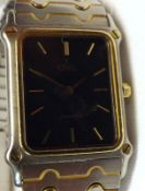 A Ladies circa 1980s Ebel Quartz Movement Dress Watch with gold batons to a black dial, 1” x ¾”,