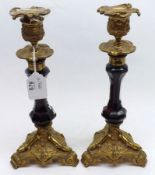 An unusual pair of late 19th/early 20th Century Brass and Glass Candlesticks, raised on three footed