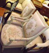 A pair of 19th Century Armchairs, with cream painted frames, swept arms and upholstered in floral