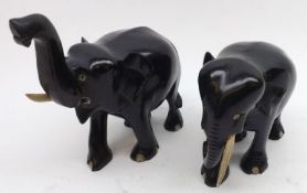 Two Ebony Carved Elephants, both lacking one tusk, the largest 5 ½” high