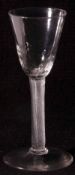 An 18th Century Wine Glass with conical dimpled bowl, air twist stem and spreading circular foot,
