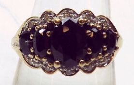 A yellow metal five graduated dark blue Sapphire and ten small brilliant cut Diamond Cluster Ring,