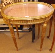 An unusual oval Gilt Painted Bijouterie Display Table, the glazed lid opening to reveal a pink-lined