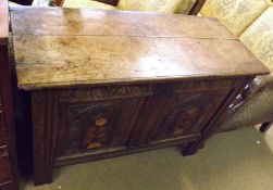 An 18th Century Oak Coffer of typical form, the two plank top opening to an interior fitted with