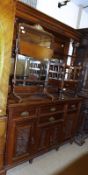 A substantial Victorian American Walnut Mirror Back Sideboard, the moulded cornice to a carved