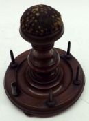 A Turned Mahogany Sewing Stand, the round base fitted with six spikes for cotton reels, the pedestal