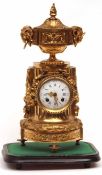 A late 19th Century French Gilt Metal Cased Mantel Clock, the top crested with a lidded compartment,