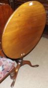 A 19th Century Mahogany Tripod Base Table, the round top raised on a turned column to three