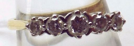 A hallmarked 18ct Gold five small brilliant cut Diamond Ring, claw setting