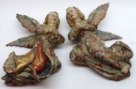 A pair of wall mounted Vintage Wooden Angels, painted in colours with gilt highlights