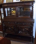 A Victorian Gothic Carved Oak Side Cabinet, the moulded cornice to a carved frieze above a glazed