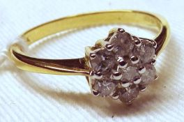 A modern hallmarked 18ct Gold seven small brilliant cut Diamond Cluster Ring of flower head design