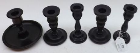 A group of five various assorted Ebony Candlesticks, the largest 5” high