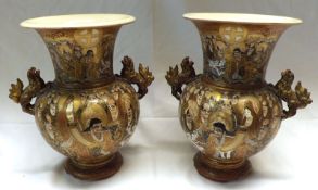 A pair of Satsuma Two-Handled Baluster Vases, painted in colours with panels of immortals and