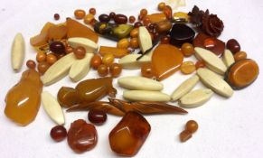 A box containing assorted Amber Bead Brooches, oddments and Bone pieces (qty)