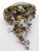 A 20th Century Continental Wall Bracket, heavily decorated with coloured floral encrustations,