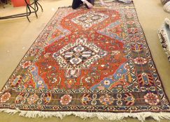 A large Caucasian Carpet with triple gull border, central panel of lozenges and geometric design,