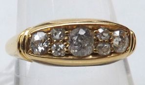 An Edwardian period hallmarked 18ct Gold Ring, the boat-shaped front set with seven graduated old