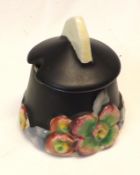 A Clarice Cliff “My Garden” Lidded Mustard Pot, black body and coloured relief moulded floral