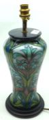A modern Moorcroft Table Lamp, tall tapering design decorated with blue flowers and foliage,