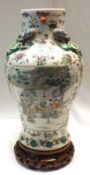 A Japanese large Baluster Vase, the neck moulded with dragons and the body painted predominantly