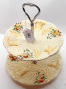 A Clarice Cliff “Celtic Harvest” two tier Cake Stand with central chromium shaft and handle, 8 ¾”