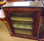 A Victorian Walnut Veneered Pier Cabinet with single glazed door, opening to reveal a two shelved