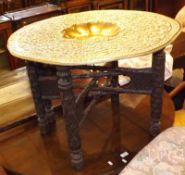 An early 20th Century Brass Tray Top Benares Table, the round top to a six-legged hardwood base with