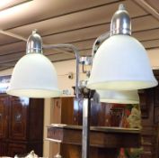 An Art Deco three branch Standard Lamp, fitted with three opaque glass shades, to a chrome