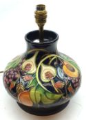 A modern squat Moorcroft Table Lamp, extensively decorated with fruit and leaves in green, pink,