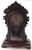 A late 19th/early 20th Century Gingerbread type Mantel Clock, oak case crested with roundels and