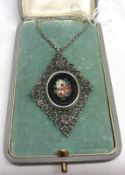 An early.mid 20th Century German Cased white metal Filigree Pendant, diamond shaped with Pietra Dura