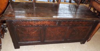 A late 17th/early 18th Century Pine and Oak Coffer, the three panelled front carved with floral