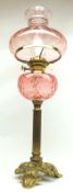 A late Victorian/early 20th Century Oil Lamp, fitted with a light pink glass shade, to a light