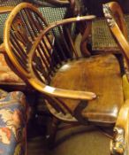 An early 19th Century Windsor type Armchair, the swept yew stick back to an elm seat, front turned