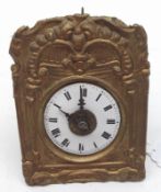 A small European Wall Clock with alarm movement, the pressed brass front decorated with scrolls