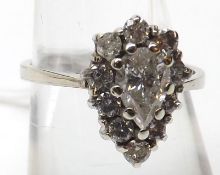 A high grade precious metal pear-shaped Ring set with a centre pear-shaped Diamond surrounded by ten