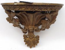 A Giltwood and Gesso Wall Bracket of demi-lune form, the edge moulded with foliate detail, raised on