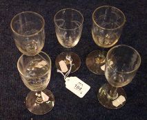 A collection of five various Decorative Wine Glasses, all circa early 20th Century, each engraved