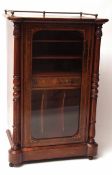 A Victorian Walnut Veneered Music Cabinet, the top with brass gallery rail, to a single glazed