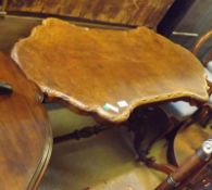 A Victorian Side Table, the formerly veneered shaped top to a two pedestal base with stretchers,