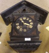 An early 20th Century Ebonised Cased Cuckoo Clock with arched top over aperture enclosing cuckoo,