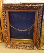 PAIR OF 20TH CENTURY CARVED AND FRETWORK PICTURE FRAMES, possibly Indian, 18” x 23 ½” (2)