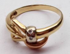 A modern high grade precious metal Bow Design Ring, set with a band of three small brilliant cut