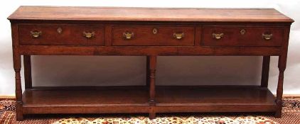 An 18th Century and later Oak Dresser Base, the top with moulded edge over three frieze drawers,