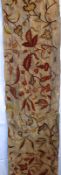 A 19th Century Long Crewelwork Panel, formerly part of a bed hanging set, features a design of